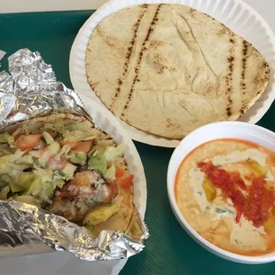 a plate of pita and a bowl of dip