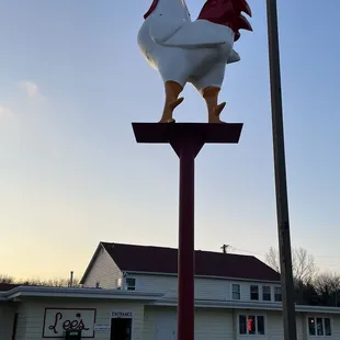 a rooster on a pole