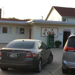 two cars parked in front of the restaurant