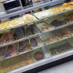 a variety of donuts in a display case