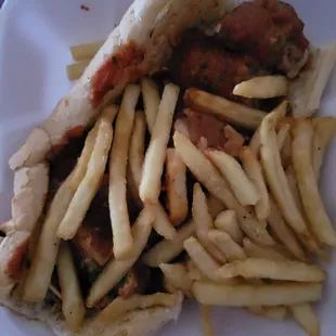 Meatball poboy with sauce and  very little cheese with fries thrown on top without a care. Sandwich was not dressed.