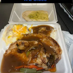 Porkcop (smothered) with 2 sides (rice+gravy and loaded mash potato)