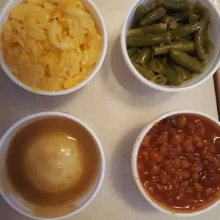 three bowls of beans and a bowl of macaroni and cheese