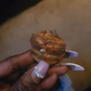 a hand holding a fish