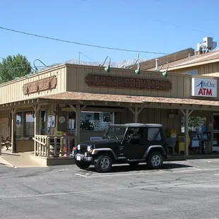 a jeep parked in front of the store