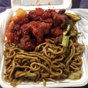 a take out container with noodles and meat