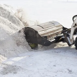 a snow plow clearing a pile of snow