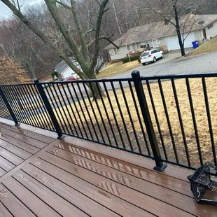 a deck with railings and a bench