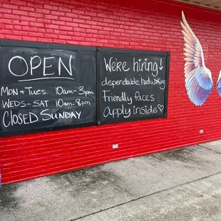 a red brick building with a sign that says open