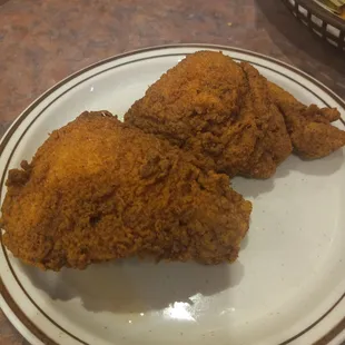 two pieces of fried chicken on a plate