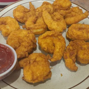 a plate of fried shrimp with ketchup