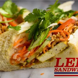 VEGAN Tofu Deluxe Banh Mi. Crispy slices of Lemon Grass Tofu with our Traditional Shredded Tofu mix. So much flavor for a vegan sandwich!