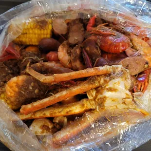 The Ultimate their sauce: Crawfish, Sausage, Clams, Shrimp, Snow crab, potatoes, and corn.