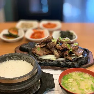 Korean BBQ Kalbi entree accompanied with bowl of rice, warm Miso soup, and assortment of bonchon.