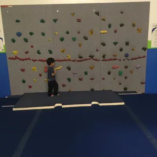 Climbing rock wall (not allowed to climb higher than the red line)