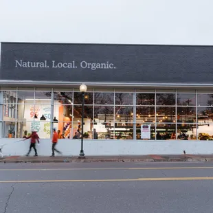 two people walking in front of a store