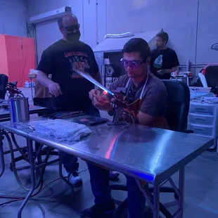 My husband blowing glass.