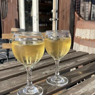 two glasses of wine on a wooden table