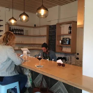 a man and a woman sitting at a bar