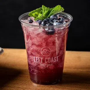 a cold drink with blueberries and mint