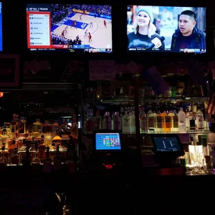 a bar with multiple televisions