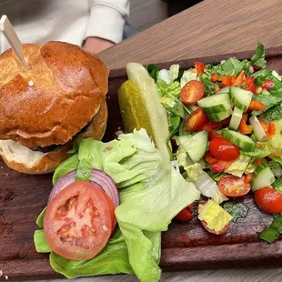 Burger with side salad. Burger is handmade patty with brioche bun. salad is fresh and delicious!