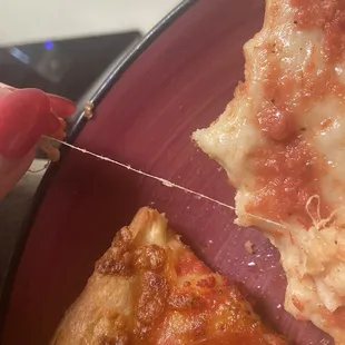 String found in a slice of pizza, very clearly made of cloth...