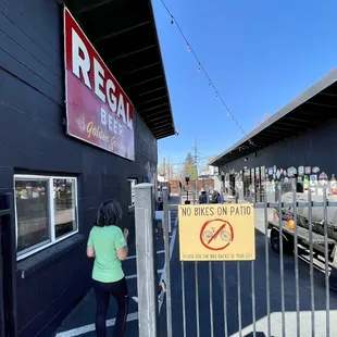a woman standing in front of a closed gate