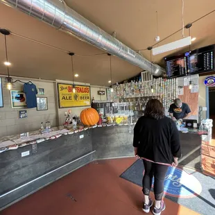 a woman standing in front of a counter