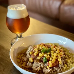 Seasonal food specials. Summer bowl, yellow rice, pulled pork, pineapple salsa, korn and green onions.