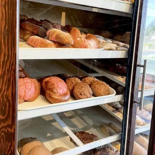 a variety of baked goods in a display case