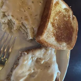 a plate of food with mashed potatoes and gravy