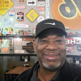 a man in a black jacket and hat