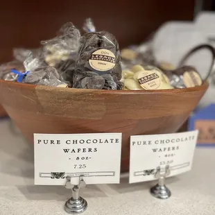 a wooden bowl filled with chocolates
