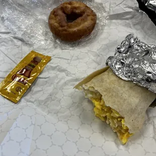 Breakfast burrito, cake donut, cholula hot sauce