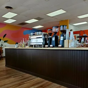 a coffee bar with a colorful wall