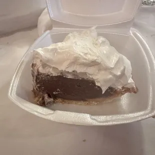 a piece of pie in a styrofoam container