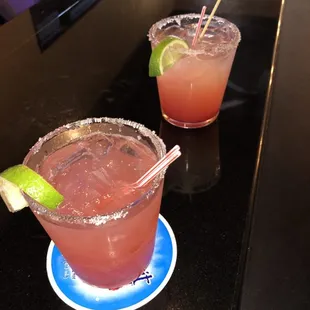 two margaritas with a lime garnish