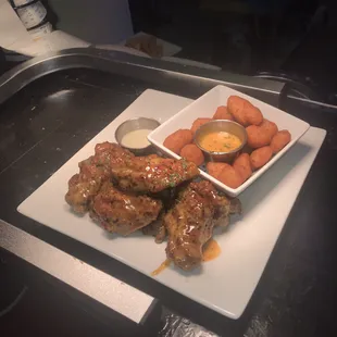 a plate of chicken wings and carrots