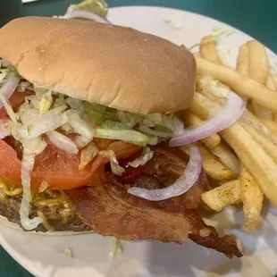 Loaded burger with bacon and fries.
