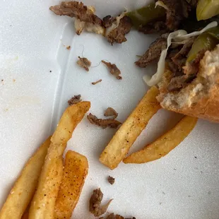 a half eaten sandwich and french fries