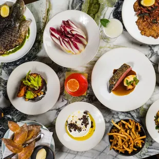 a variety of dishes on a marble table