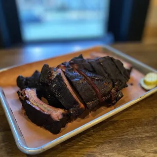 a plate of ribs on a wooden table