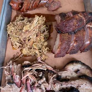 a tray of meat and sides