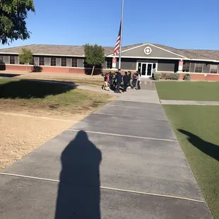 Kids gathered around the flagpole