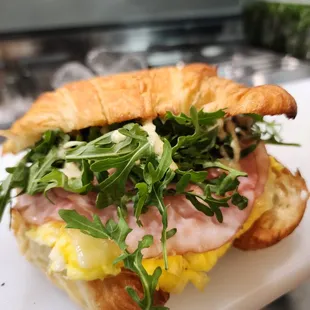 a croissant sandwich on a cutting board