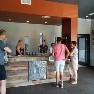 a group of people standing at a bar