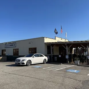 a white car parked in front of a building