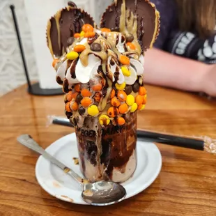 a chocolate sundae topped with candy, marshmallows, and sprinkles