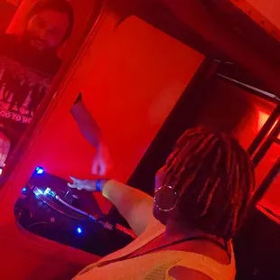 a woman with dreadlocks playing a dj